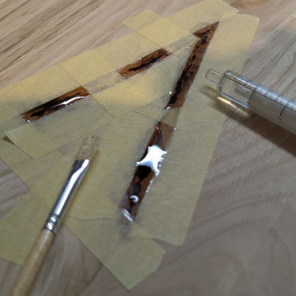 schilderstape als afscheiding en injectiespuit als vulinstrument